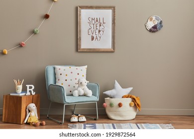 Cozy Interior Of Child Room With Mint Armchair, Brown Mock Up Poster Frame, Toys, Teddy Bear, Plush Animal, Decoration And Hanging Cotton Colorful Balls. Beige Wall. Warm Kid Space.  Template. 