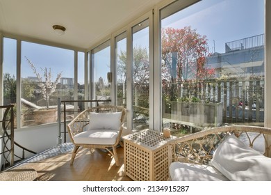Cozy interior covered veranda with panoramic windows - Shutterstock ID 2134915287