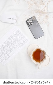 A Cozy and Inviting Workspace Featuring Tea, Technology, and Comfort for Productivity