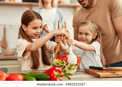 In a cozy kitchen, parents and kids connect while preparing a fresh vegetable salad, cherishing family time and cooking together in a warm atmosphere - Powered by Shutterstock