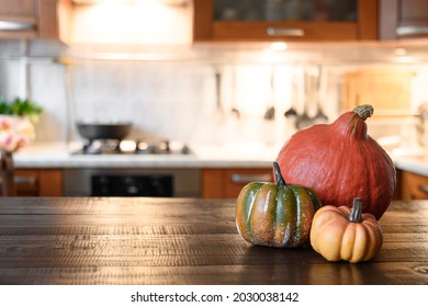 Cozy Kitchen With Pumpkins For Thanksgiving Day Or Halloween Cooking On Wooden Table Top.