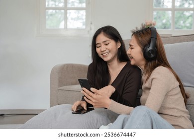 Cozy Lesbian Couple Relaxing in Modern Living Room, Enjoying Quality Time Together with Technology and Comfort - Powered by Shutterstock