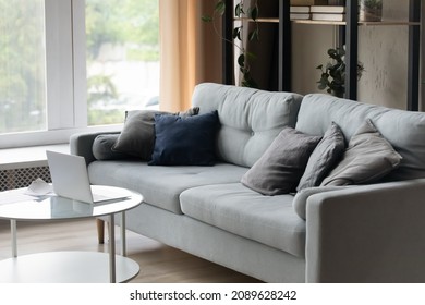 Cozy Light Living Room With Grey Sofa And Laptop On Coffee Table, No People. Empty Domestic Room, Cosy Homeoffice Space At Home, Modern Furniture Store Advertisement, Tenancy And Accommodation Concept