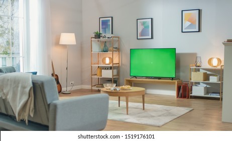 Cozy Living Room With Stylish Furniture And Design, Green Chroma Key TV In The Middle Of The Room.