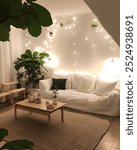 Cozy living room with white couch, wooden coffee table, string lights, and plants.