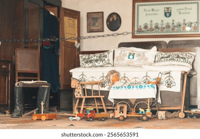 A cozy living space showcases an array of vintage toys and a rustic sofa adorned with handmade textiles. The warm, inviting atmosphere evokes memories of simpler times