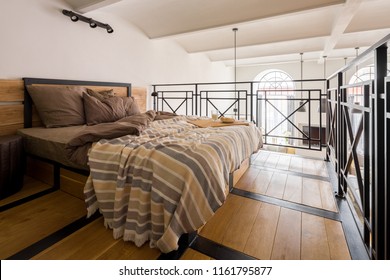 Cozy Mezzanine Bedroom With Double Bed And Wooden Floor