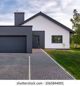 Cozy And Modern House With Garage And Cobblestone Driveway