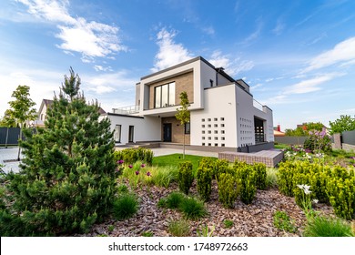 Cozy and modern house with garage and cobblestone driveway. Modern architecture. - Powered by Shutterstock