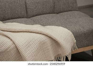 Cozy Modern Living Room Sofa with Soft Textured Blanket. - Powered by Shutterstock