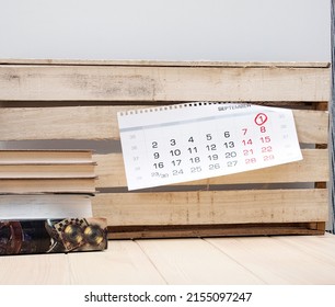 Cozy Modern Office Room With Wooden Comfortable Table With Different Books And Wooden Craft Wall With Shit Of Calendar, Ready For Coworkers 