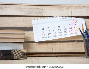 Cozy Modern Office Room With Wooden Structure Surface Comfortable Table With Different Books And Wooden Craft Wall With Shit Of Calendar, Ready For Coworkers At Open Space Office.