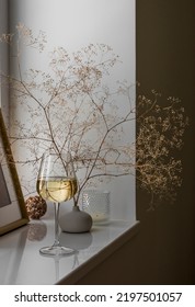 Cozy Mood - A Glass Of White Wine On The Windowsill In A Scandinavian Interior      