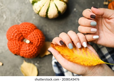 Cozy nails design. autumn leaves. A place for text. cozy autumn fall concept. Trendy manicure.