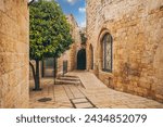 Cozy narrow small Street in the Old City of Jerusalem, Israel. Typical stoned houses and walls of jewish historic quarter area part.