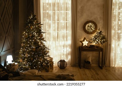 Cozy New Year's interior. Large Christmas tree decorated with bright garlands and golden stars in a cozy bedroom on Christmas Eve. Festive lights in the interior. Christmas background. Holiday magic