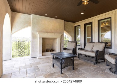 Cozy outdoor seating area with fireplace overlooking scenic landscape - Powered by Shutterstock