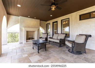 Cozy outdoor seating area with fireplace and scenic view - Powered by Shutterstock