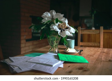 A Cozy Place To Relax At Home. Preparing For Math Exams At Home. A Bouquet Of Peonies And A Cup Of Tea For A Cozy Atmosphere. The Concept Of Comfort Of Rest. Real Life.