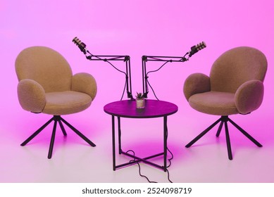 Cozy podcast setup with two chairs and microphones against a vibrant pink background - Powered by Shutterstock