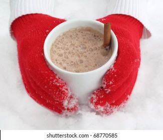 Cozy Red Gloves Hold A Mug Of Hot Cocoa On A Snowy Day