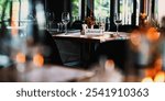 Cozy restaurant with a reserved table. Elegant tableware, reserved sign, and warm lighting create an inviting dining atmosphere. Table reserved at cozy and elegant restaurant.