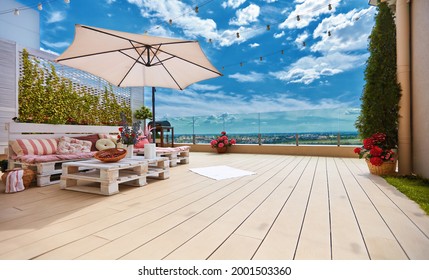 cozy rooftop patio with pallet furniture lounge zone and beautiful landscape view - Powered by Shutterstock