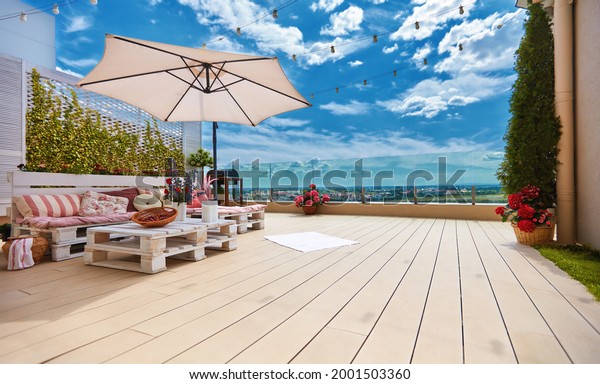 cozy rooftop patio with pallet furniture\
lounge zone and beautiful landscape\
view