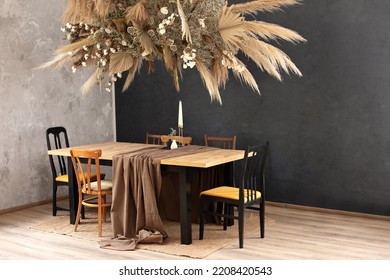 Cozy Room Decorated With Fall Decor. Stylish Dinning Room With Wooden Table And Chairs. Holiday Family Dinner. Kitchen Interior With Furniture. Living Room WithComposition Dry Decoration Plant On Wall