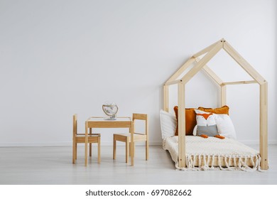 Cozy Room For Kids With A Comfortable, Wooden Bed, And A Small Table