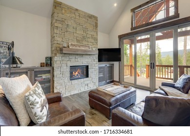 Cozy Rustic, New Luxury Living Room Interior Design With Large Stone Fireplace And Leather Sofas,