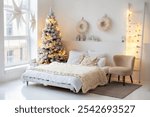 Cozy Scandinavian white Interior design bedroom with christmas tree and bed and pillows, beige armchair and decorative stepladder with garland. Decoration White Christmas stars in window. A lamp star