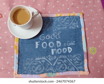 A cozy setup featuring a steaming cup of tea evoking a sense of comfort and positivity. The warm ambiance, soft lighting, and appetizing dishes create a perfect 