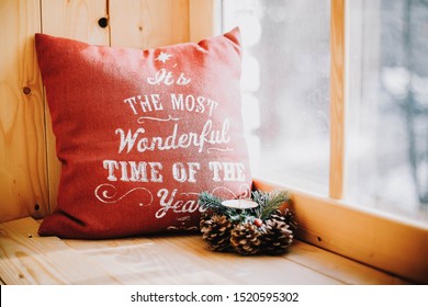 Cozy Small Window Sill With Christmas Decorations And A Red Pillow