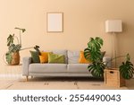 Cozy sofa, lamp and Monstera houseplants in interior of living room