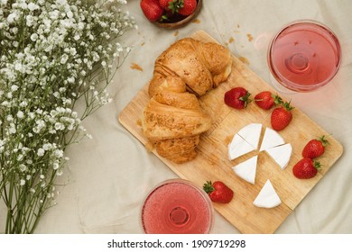 Cozy Spring Or Summer Picnic At Home. Romantic Picnic For Valentine's Day On February 14 With Croissant, Strawberries, Cheese And Rose Champagne. Protea And Gypsophila Flower.