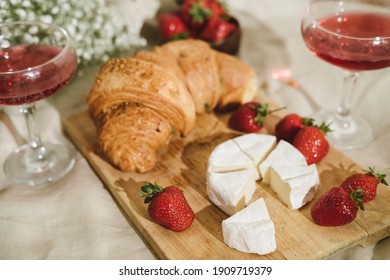 Cozy Spring Or Summer Picnic At Home. Romantic Picnic For Valentine's Day On February 14 With Croissant, Strawberries, Cheese And Rose Champagne. Protea And Gypsophila Flower.