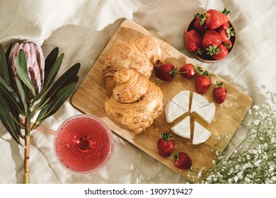 Cozy Spring Or Summer Picnic At Home. Romantic Picnic For Valentine's Day On February 14 With Croissant, Strawberries, Cheese And Rose Champagne. Protea And Gypsophila Flower.