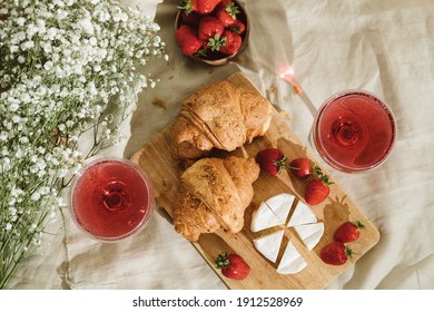 Cozy Spring Or Summer Picnic At Home. Romantic Picnic For Valentine's Day On February 14 With Croissant, Strawberries, Cheese And Rose Champagne. Protea And Gypsophila Flower.