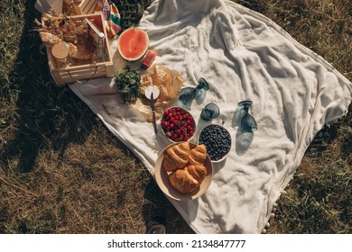 Cozy Spring Or Summer Picnic At Home. Romantic Picnic With Croissant, Fruits, Cheese And Drinks.