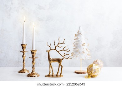 Cozy still life with burning candles, figure of deer and Christmas decorations on pastel light background. Christmas composition for home interior
. - Powered by Shutterstock