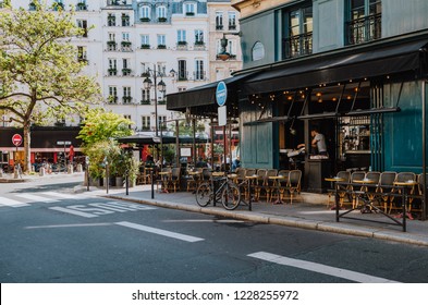 Cozy street with tables of cafe  in Paris, France - Powered by Shutterstock