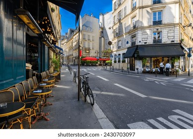 Cozy street with tables of cafe  in Paris, France. Cityscape of Paris. Architecture and landmarks of Paris - Powered by Shutterstock