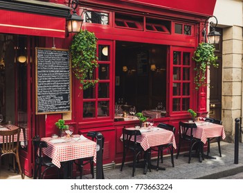 Cozy street with tables of cafe in Paris, France. Architecture and landmarks of Paris. Postcard of Paris