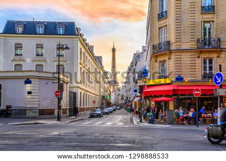 Cozy street with tables of cafe in Paris, France. Architecture and landmark of Paris. Cozy Paris cityscape.