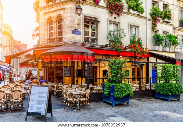 Cozy street\
with tables of cafe in Paris, France. Architecture and landmark of\
Paris. Cozy Paris cityscape.\

