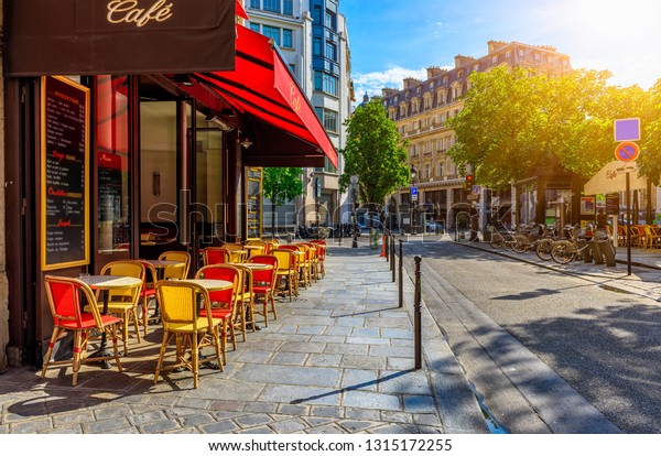 Cozy street with\
tables of cafe in Paris, France. Cityscape of Paris. Architecture\
and landmarks of Paris.