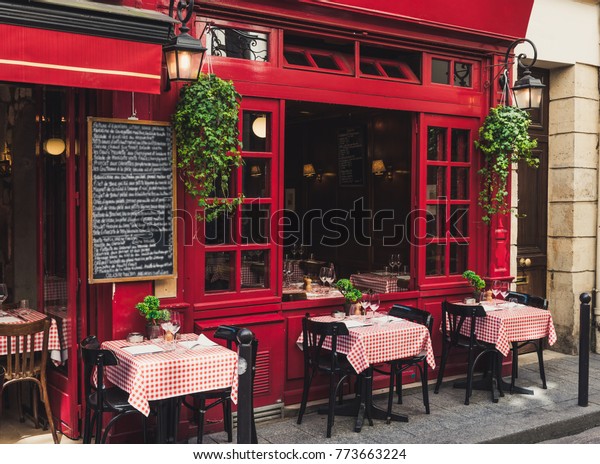 Cozy street with\
tables of cafe in Paris, France. Architecture and landmarks of\
Paris. Postcard of Paris