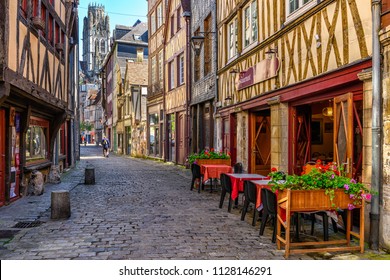 Cozy street with timber framing houses and tables of restaurant in Rouen, Normandy, France - Powered by Shutterstock