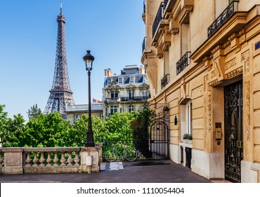 Cozy street with view of Paris Eiffel Tower in Paris, France. Eiffel Tower is one of the most iconic landmarks in Paris. Architecture and landmark of Paris